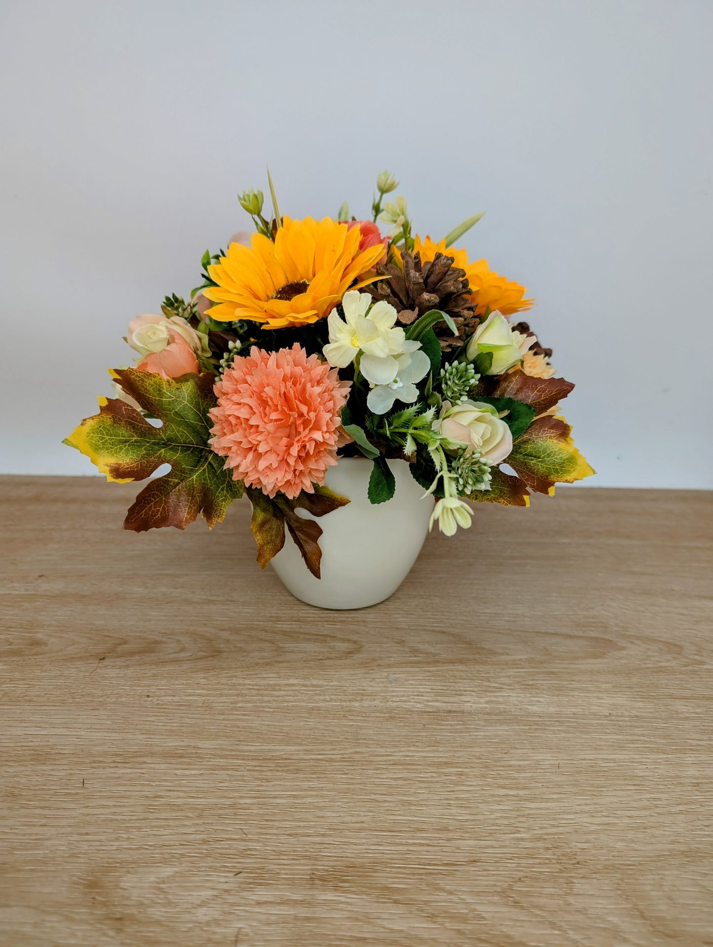 Autumn arrangement in cream pot