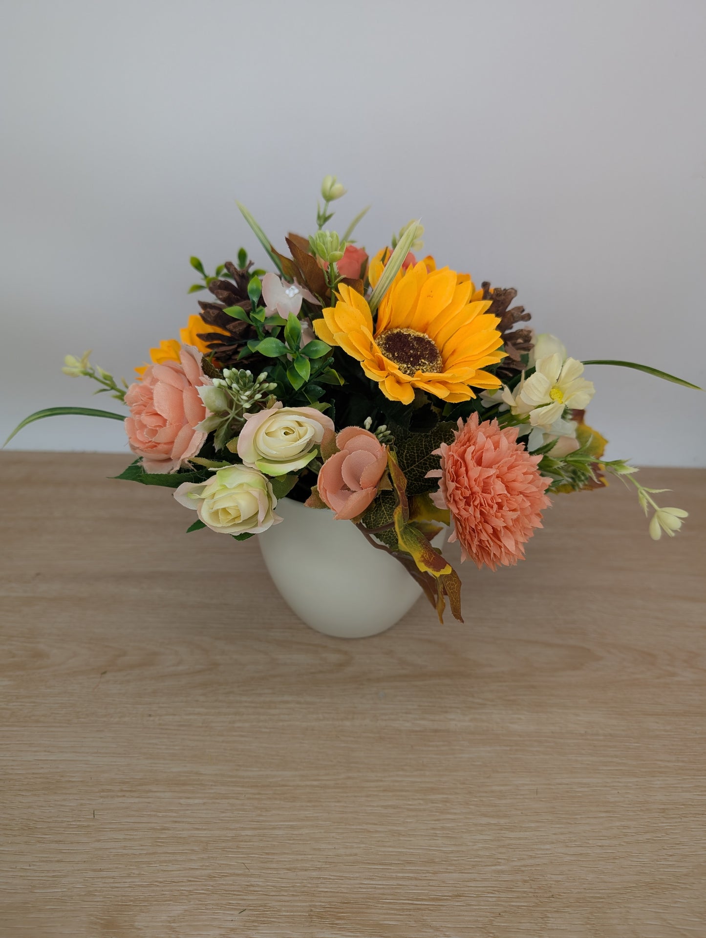 Autumn arrangement in cream pot