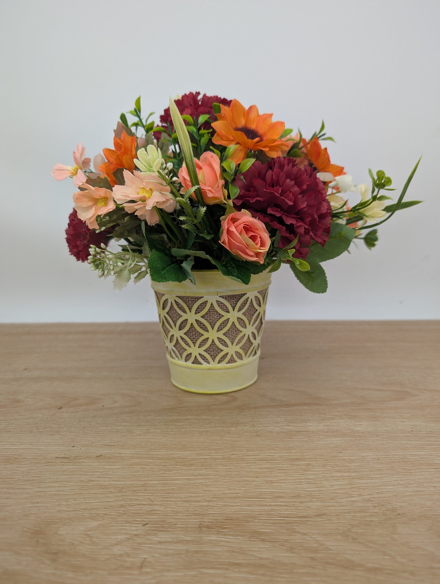 Autumn arrangement in yellow pot