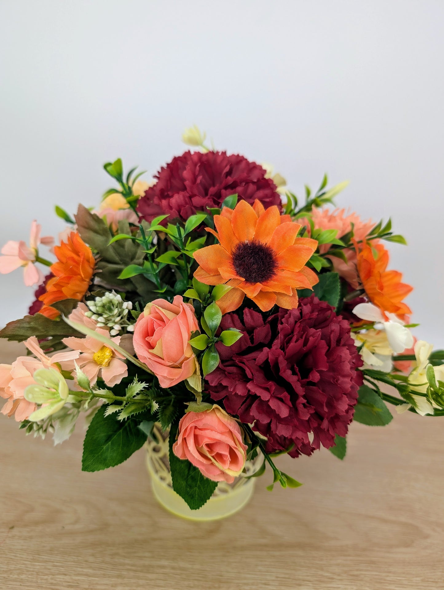 Autumn arrangement in yellow pot