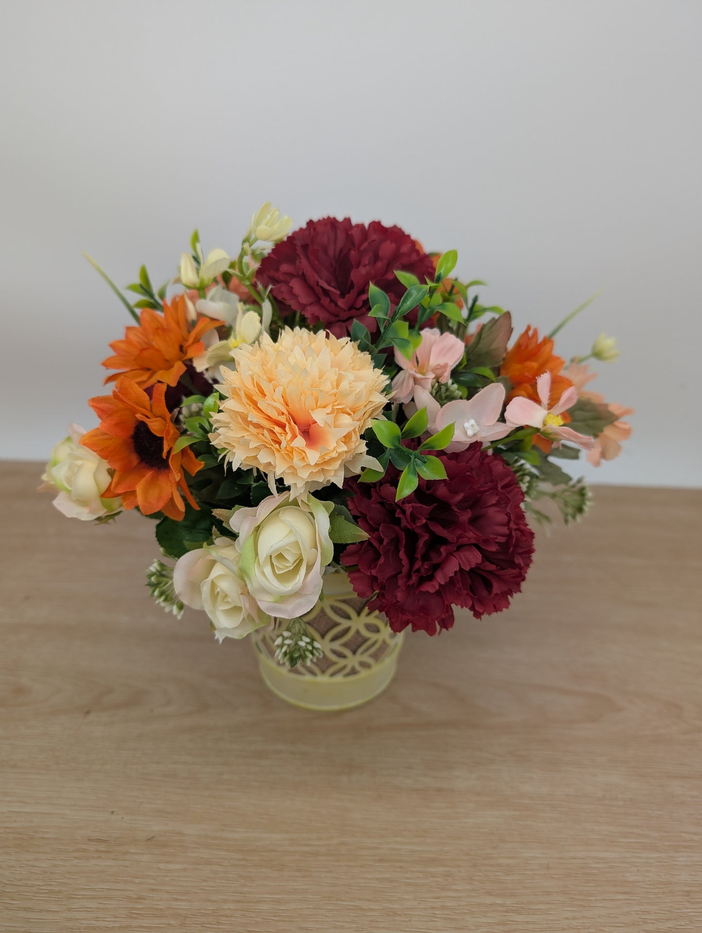 Autumn arrangement in yellow pot