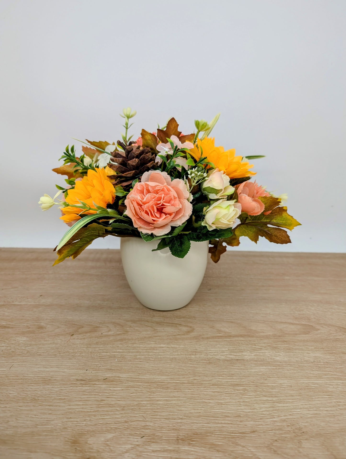 Autumn arrangement in cream pot
