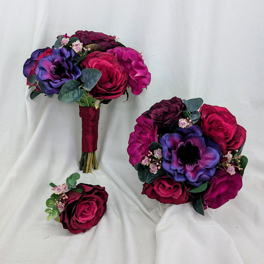 Three floral bouquets in purple and pink on a white fabric background