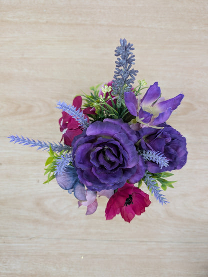Bouquet of purple and pink flowers on a wooden surface