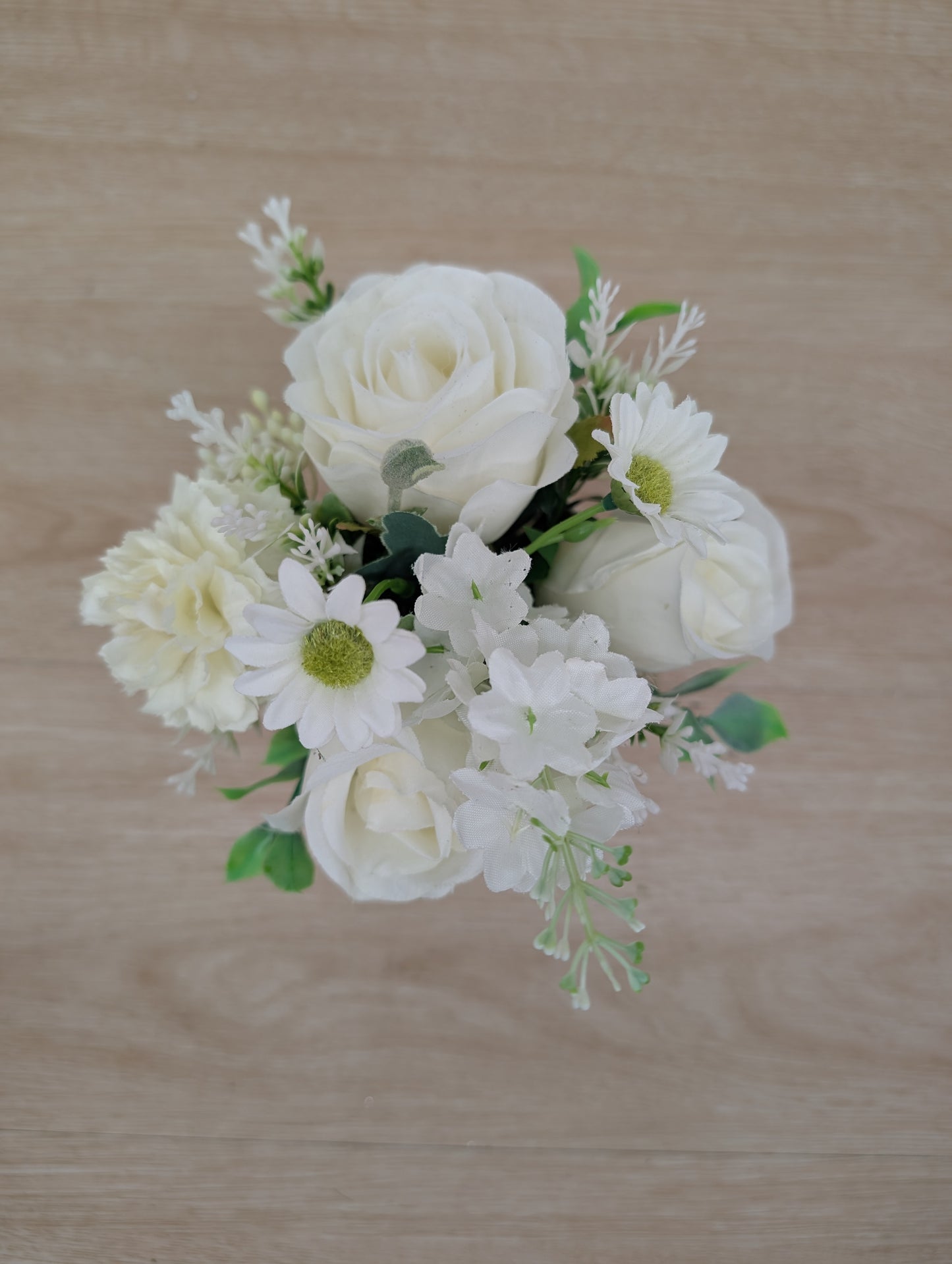 Bouquet of white flowers on a wooden surface