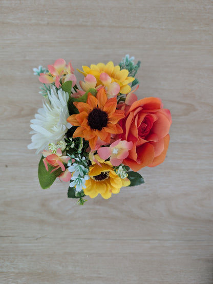 Bouquet of artificial flowers on a wooden surface